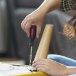 asian-woman-self-repairs-furniture-renovation-using-equipment-to-diy-repairing-furniture-sitting-on-the-floor-at-home-photo